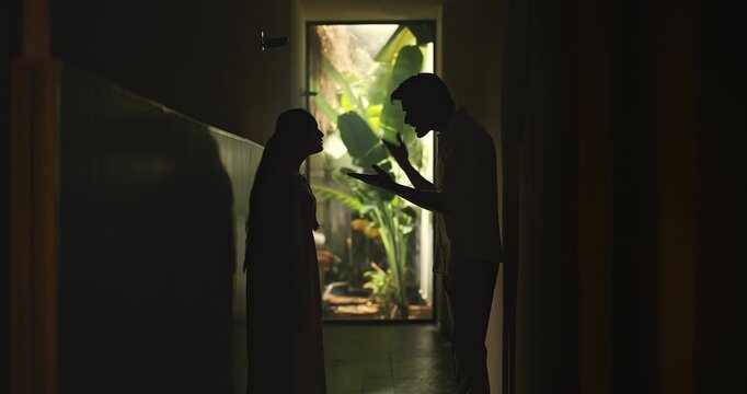 Indian upset tense young adult male female girl do fight argue shout on each other abuse living dark room place. Angry sad man woman wife couple talk speak lies feel bad have family issue money crisis