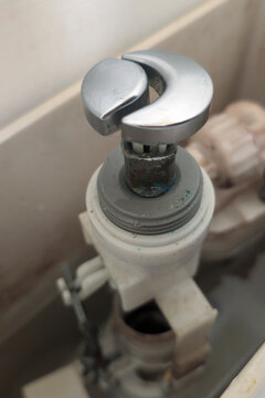 View inside a toilet flush tank showing parts and water after extended use over time