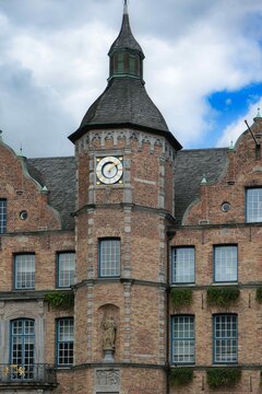 Clocktower of City Hall in Dusseldorf Germany shows the time during a cloudy day in the city