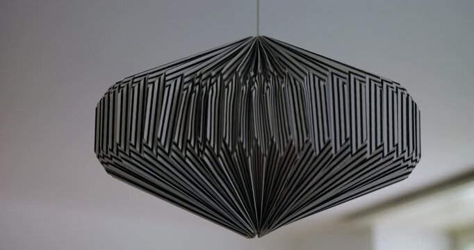 Modern geometric pendant light hanging indoors, showcasing contemporary interior design, minimalist home decor and elegant architectural style in a residential space