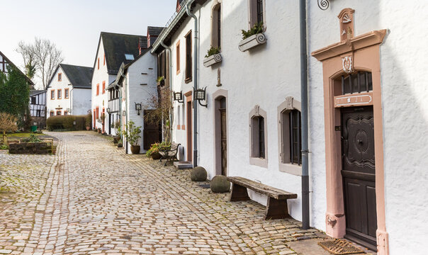 Medieval houses border an old stone paved street in Kronenburg, Germany