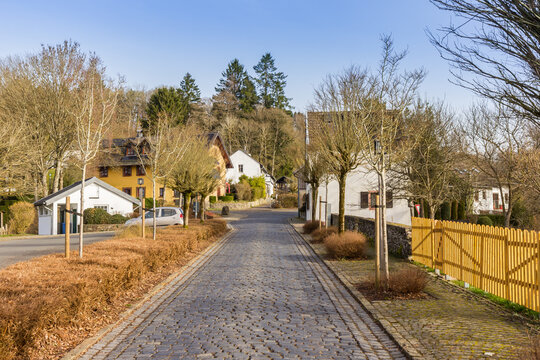 Cobblestone street winds through the historic village in Kronenburg, Germany
