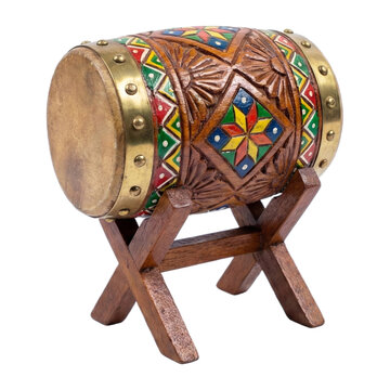 Miniature decorative Islamic bedug drum with colorful geometric patterns on a wooden stand isolated on white