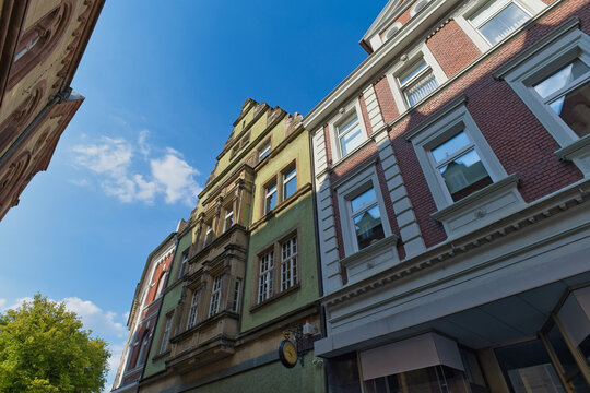 A low-angle view showcases historic European buildings with ornate gables and brick facades - Soest, Westphalia, Germany