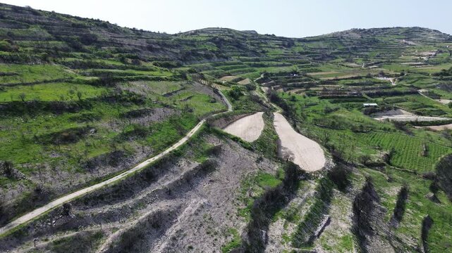 Panoramic drone shot of terraced vineyards on steep mountain slopes near Omodos, Cyprus