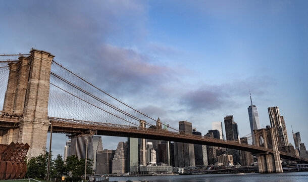 Brooklyn bridge to Manhattan. Urban architecture of New York city sunset. Brooklyn bridge of New York city. Brooklyn landmark. Manhattan cityscape with skyscraper architecture