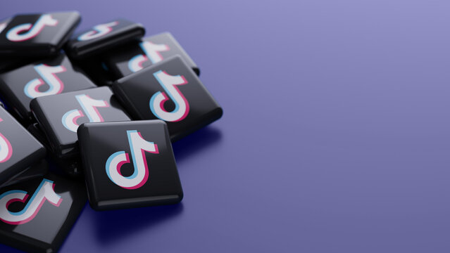 Berlin, Germany- July 31, 2026: Close-up of the TikTok logo in a pile on blue background with copy space as web banner header