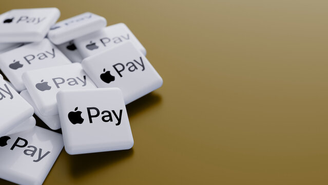 Berlin, Germany- July 31, 2026: Logo of mobile payment service Apple Pay in a pile on gold background with copy space
