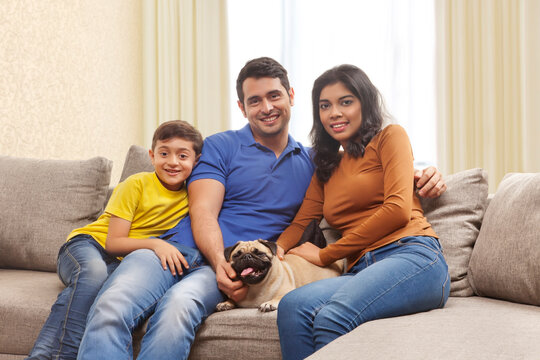 Portrait of smiling parents with son and pug 