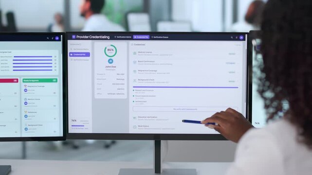 Physician Using Medical Software To Verify Credentials