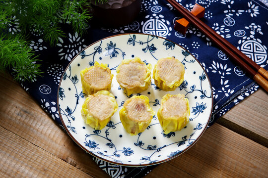 Cantonese pork siu mai dim sum on blue floral porcelain plate tea cup