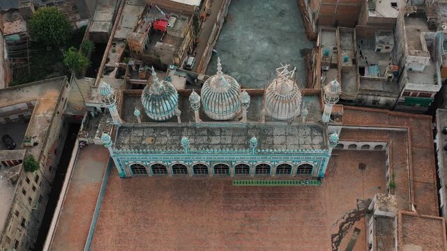 Top down shot of Jamia Masjid 4K Drone Zoom In on Historic Jamia Mosque Amid Dense Urban Neighborhood in Pakistan