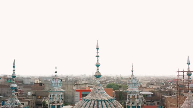 Drone Close Up of Historic Jamia Masjid Domes Above Pakistan City Skyline