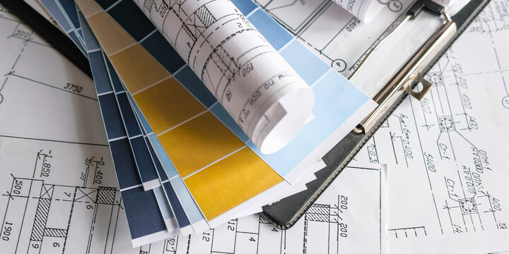 Blueprints, rolled plans and drafting tools on desk, architectural engineering workflow concept for construction planning, technical documentation, project management and building design.