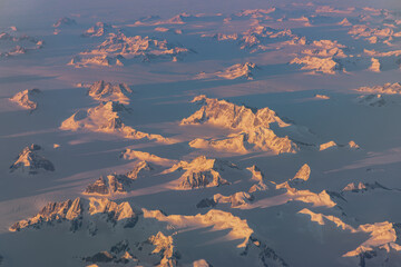 Jagged Greenland peaks rising from the ice sheet © Thomas