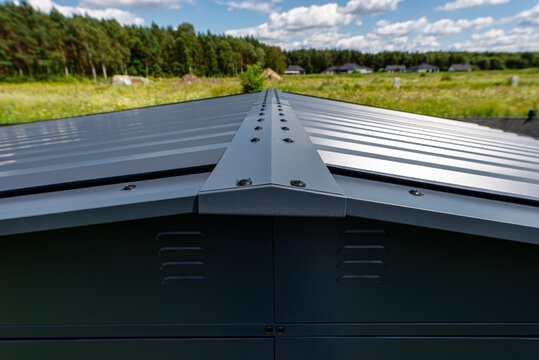 Modern metal roof ridge cap on a farmhouse