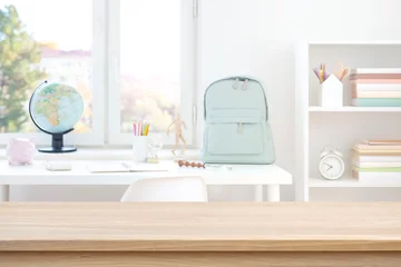 Empty wooden table with copy space on blurred modern student workplace background © didecs