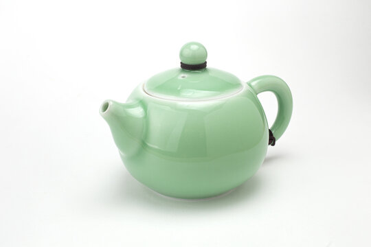 Traditional light green celadon ceramic teapot isolated on white background
