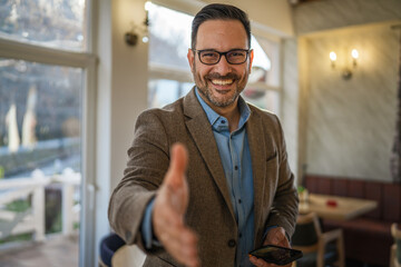 Business man offering handshake for partnership and greeting © Miljan Živković