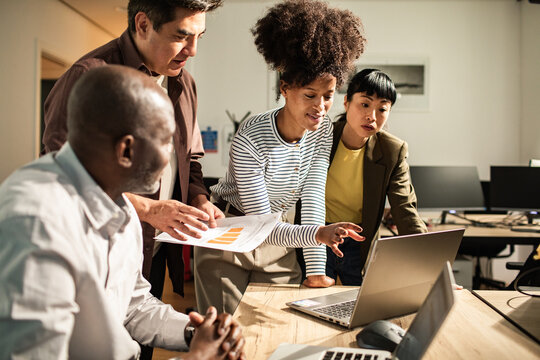 Diverse team collaborating on data in modern office