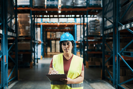 Female warehouse worker checking inventory in distribution center
