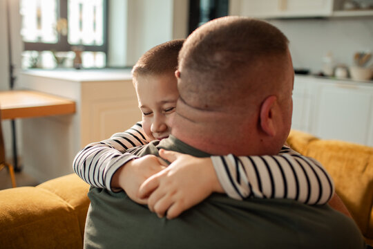 Father and son hugging at home