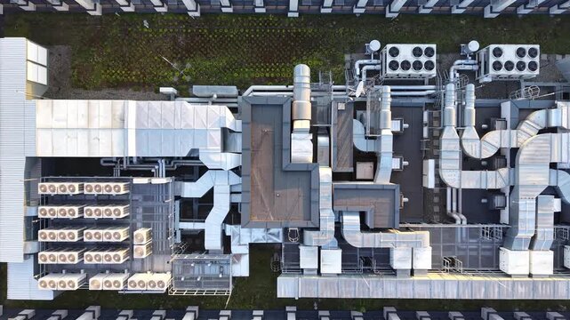 Rooftop of modern office building HVAC system with intricate ductwork and air conditioning units, showcasing the layout and design of mechanical components in a commercial setting. Aerial view