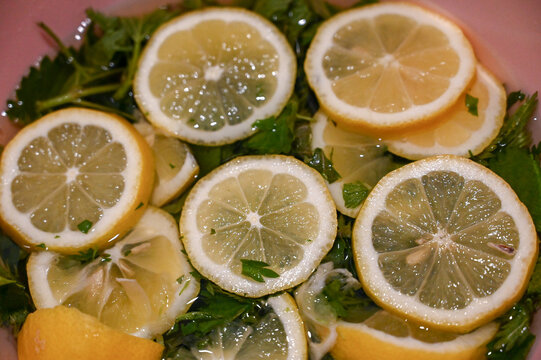 Lemon slices soaked with fresh mint leaves in water as a refreshing drink. Lemon slices and fresh mint leaves in water. Fresh juice. 