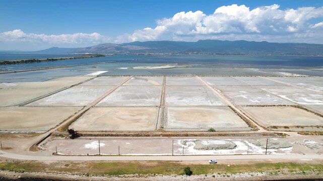 Salt Pans Area in Messolonghi (Messologgi) Greece, Aerial Trucking Shot of Tourlida Salterns, Arakinthos Mountain in Background