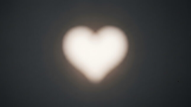 A Glowing Heart: An ethereal, softly glowing heart shape emerges from the darkness, its gentle light a beacon of warmth and affection.