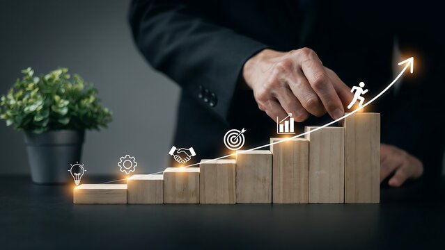 Businessman hand placing wooden block step on ascending growth chart as concept for professional progress strategy success development career achievement motivation target planning.