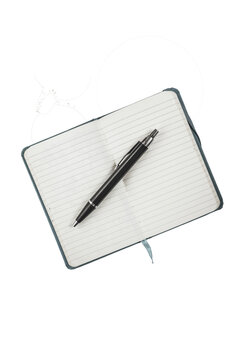 Open notebook with black pen resting on lined pages