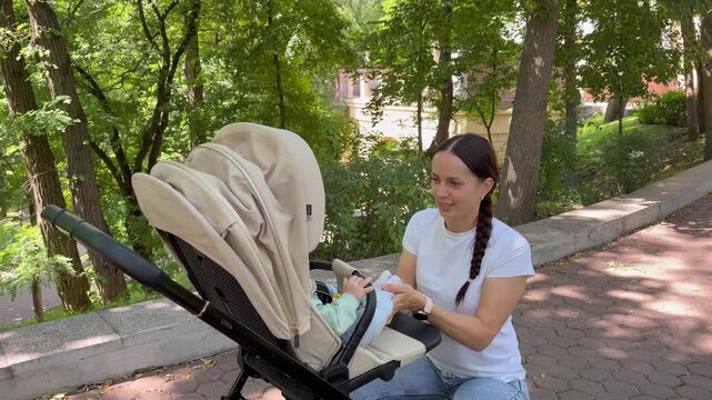 Young mother interacting with her baby in a sunny park. a warm and peaceful atmosphere of family leisure