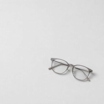 Modern transparent eyeglasses on clean white background with copy space, minimalist optical accessory concept for vision care branding and advertising