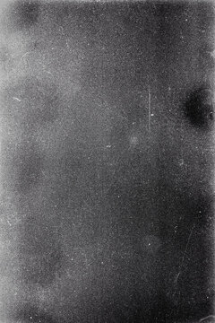 Blank grained film strip texture background with heavy grain, dust and light leak. Old expired soviet moldy photographic film scan. Black and white.