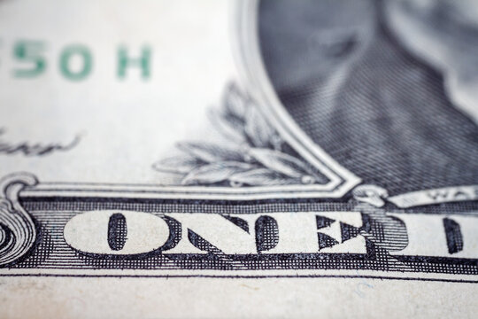 Macro close up of United States one dollar bill. American dollar background. Detailed dollars money texture. Selective focus, shallow depth of field