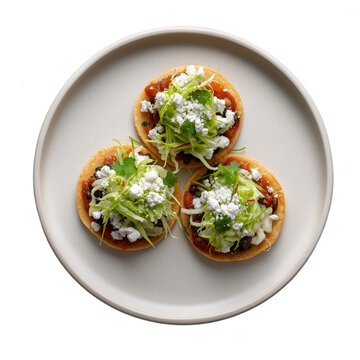 Traditional mexican sopes with refried beans, crema, queso fresco and vegetables  isolated on transparent background. Dish on the plate for menu, cafe, design.
