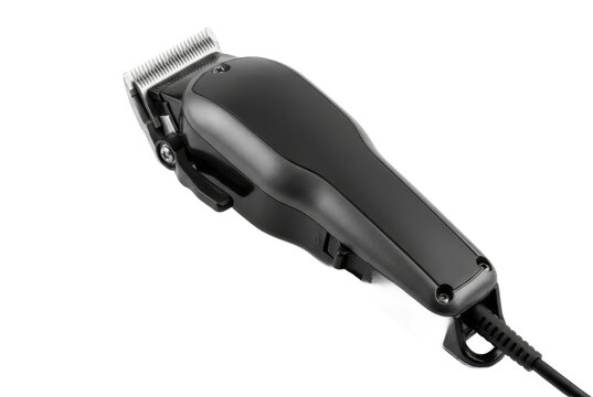 Black electric hair clippers on black background.