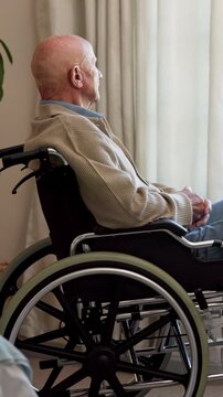 Nursing home, thinking and old man in wheelchair, retirement and contemplating choice or reflection. Remember, past and senior person with disability, regret and thoughtful with bad memory in house