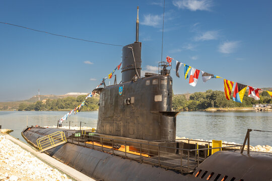 Retired Military Submarine Museum Exhibit Docked with Colorful Signal Flags, Decommissioned Military Vessel, Naval Heritage