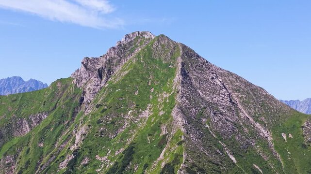 Aerial footage of the Belianske Tatry in Slovakia, featuring the mountain peaks Zdiarska Vidla and Havran. The view captures the dramatic ridgelines, rocky slopes and green alpine landscape