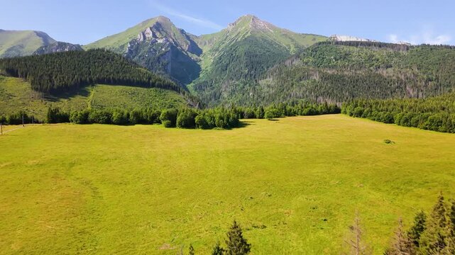 Aerial footage of the Belianske Tatry in Slovakia, featuring the mountain peaks Zdiarska Vidla and Havran. The view captures the dramatic ridgelines, rocky slopes and green alpine landscape