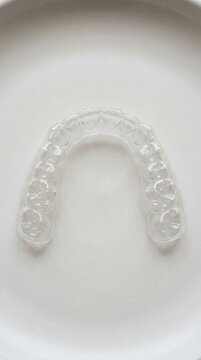 Clear Dental Aligner Tray for Teeth Straightening and Orthodontic Correction Professional Invisible Braces Appliance for a Perfect Smile and Improved Oral Health on a Minimalist Background