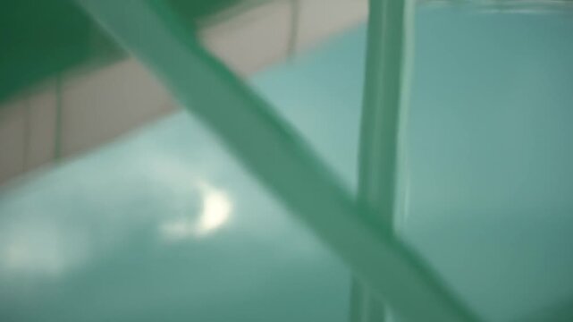 Calm Water Surface with Reflections of Sky and Green Architectural Elements
