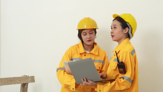 Construction inspectors and engineer discussing project details at an unfinished building site, teamwork, communication, safety compliance, site supervision, safety, construction project management.