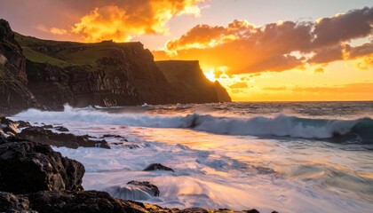 Fototapeta premium Dramatic Coastal Sunset - Waves Crashing Against Cliffs in Golden Light.