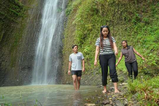 Friends Walking Along Curug Sidoharjo Waterfall Trail