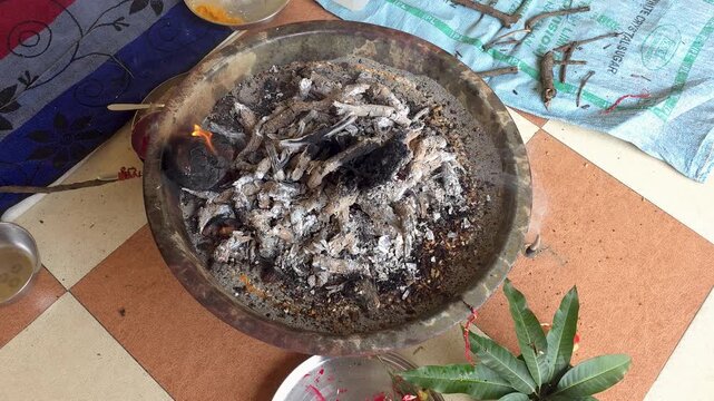 Traditional havan fire pit with glowing embers for ritual ceremony close up overhead view