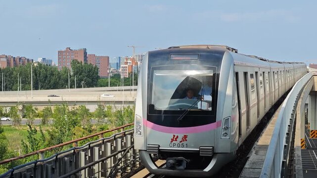 Beijing Subway Changping line elevated train driving in Life Science Park station during summer sunset