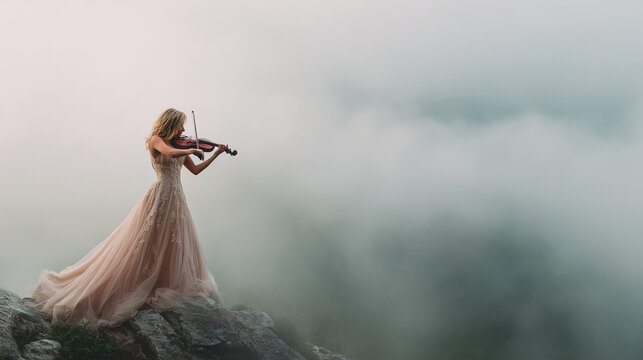 Violinist playing on mountaintop with ethereal fog and copy space
